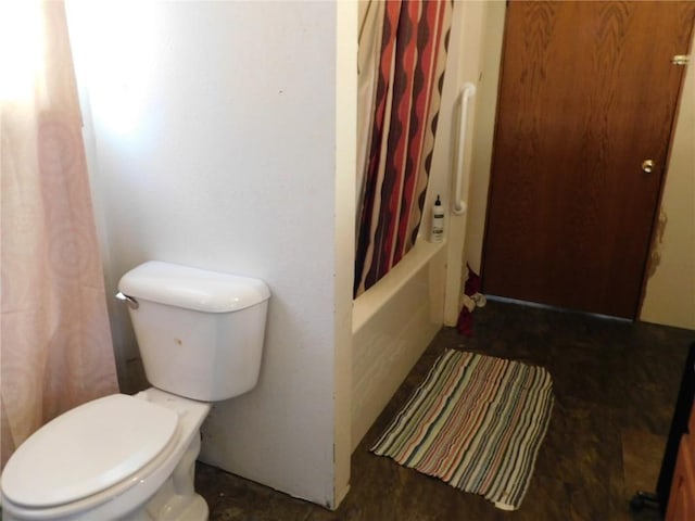 bathroom with shower / bath combination with curtain and toilet