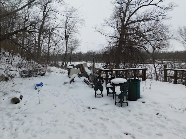 yard layered in snow featuring a garage