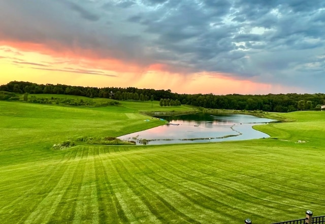 view of community featuring a water view and a lawn