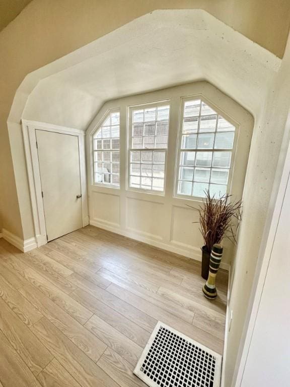 bonus room featuring light wood-style floors and visible vents