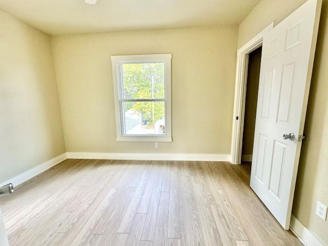 unfurnished room featuring light wood-style flooring and baseboards