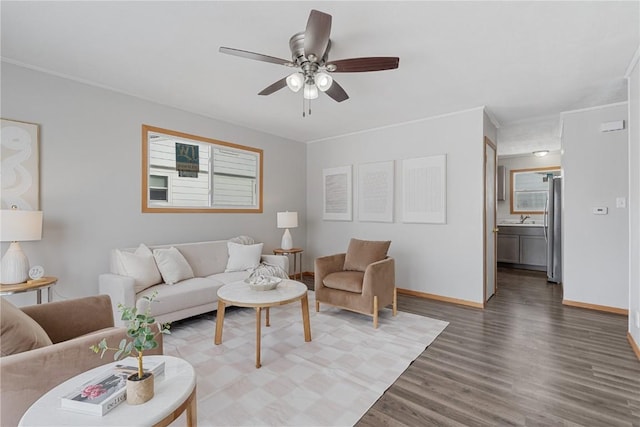 living room featuring baseboards, dark wood finished floors, and a ceiling fan