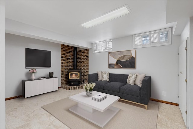 living area with light carpet, a wood stove, and baseboards