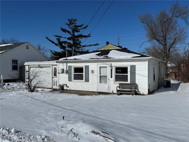 view of front of property with an attached garage and central air condition unit