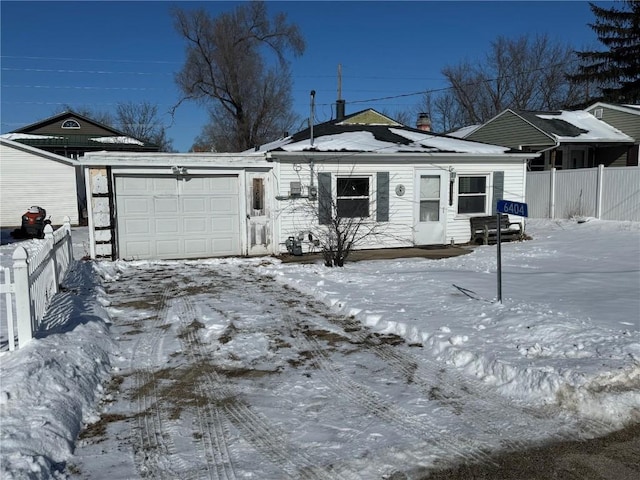 view of front of house with a garage and fence