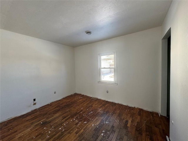 unfurnished room featuring dark wood-style flooring