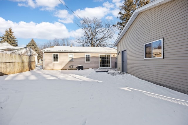 rear view of property featuring fence