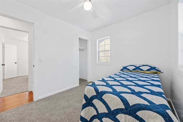 carpeted bedroom featuring a closet, ceiling fan, and baseboards