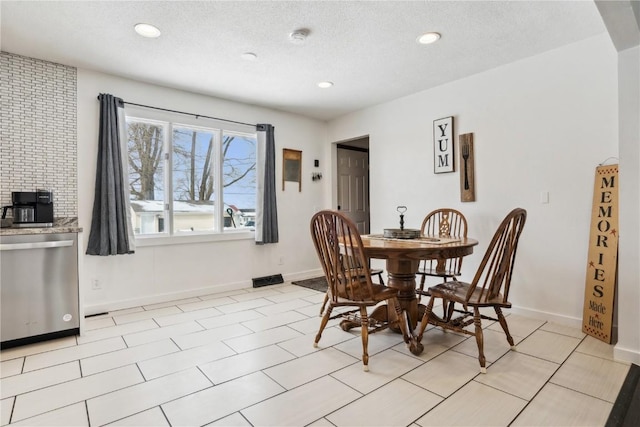 dining area featuring a textured ceiling, recessed lighting, and baseboards