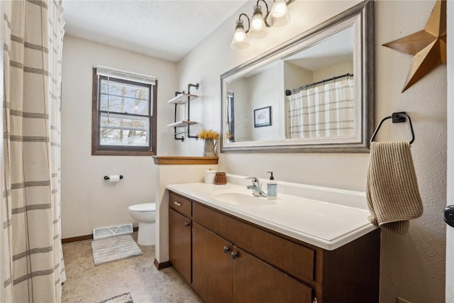 full bath featuring baseboards, visible vents, toilet, a textured ceiling, and vanity