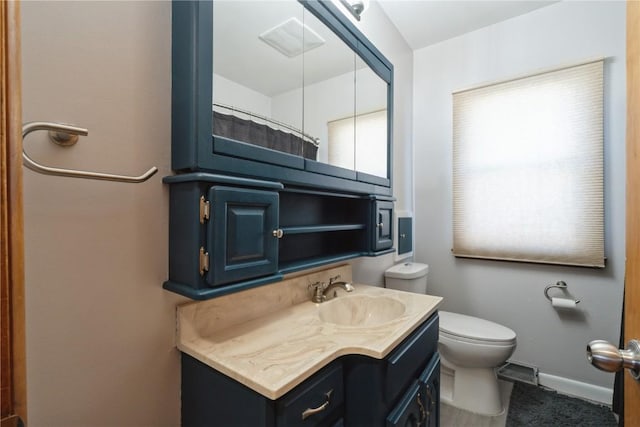 bathroom with baseboards, visible vents, vanity, and toilet