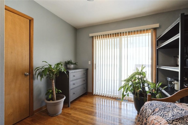 bedroom featuring baseboards and wood finished floors