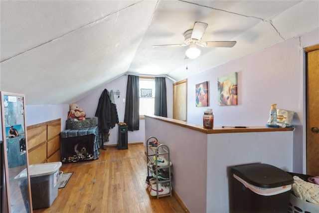 interior space with lofted ceiling, ceiling fan, and light wood-style flooring