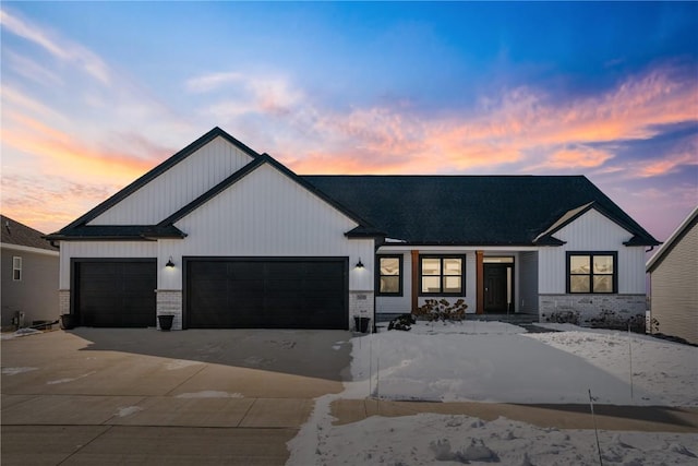 modern inspired farmhouse featuring a garage and concrete driveway