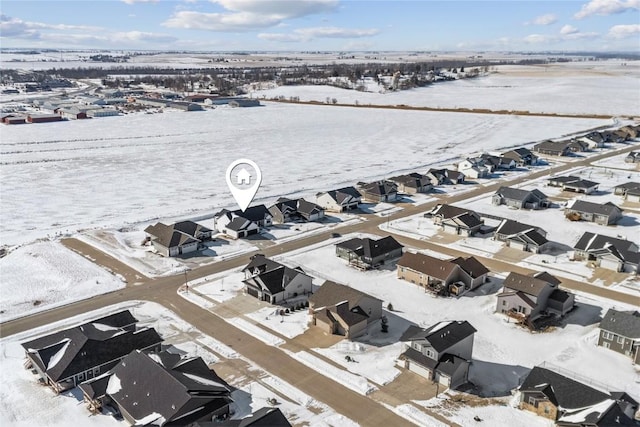 snowy aerial view with a residential view