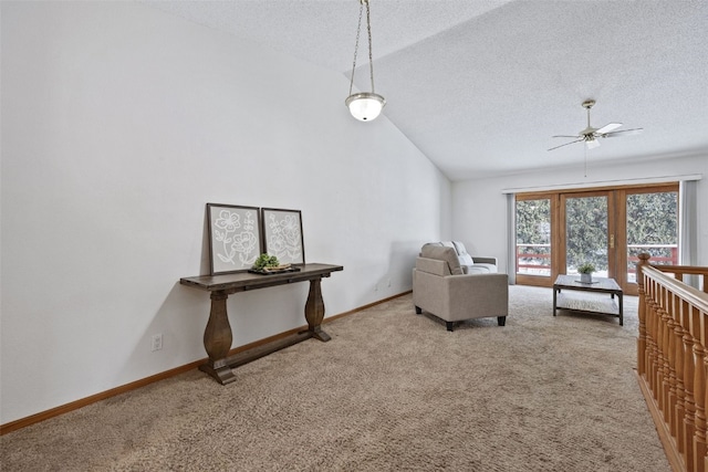 interior space with light carpet, vaulted ceiling, and a textured ceiling