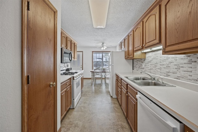 3440 Sunburst Ave, Marion, IA 52302 - kitchen featuring a textured ceiling, tasteful backsplash, a sink, light countertops, and white appliances