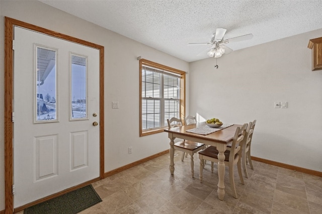 3440 Sunburst Ave, Marion, IA 52302 - dining room with a ceiling fan, baseboards, and a textured ceiling