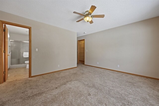 3440 Sunburst Ave, Marion, IA 52302 - unfurnished bedroom with baseboards, a textured ceiling, carpet, and ensuite bath