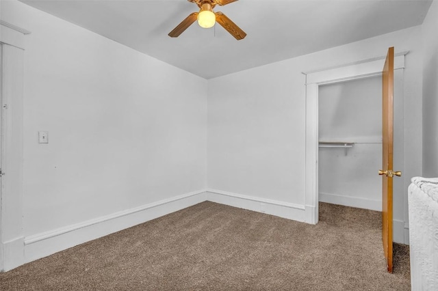 unfurnished bedroom with a closet, carpet flooring, a ceiling fan, and baseboards