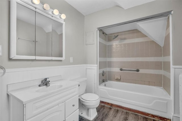 bathroom featuring washtub / shower combination, vanity, toilet, and wood finished floors