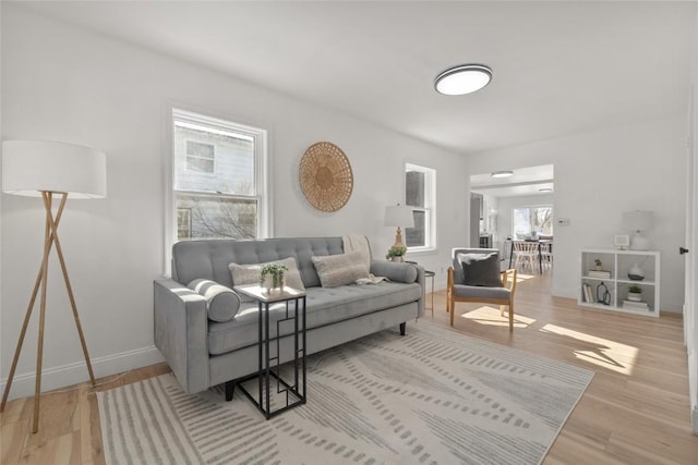 living room with light wood-style flooring and baseboards