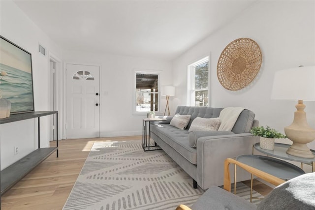 living room with light wood-type flooring and visible vents