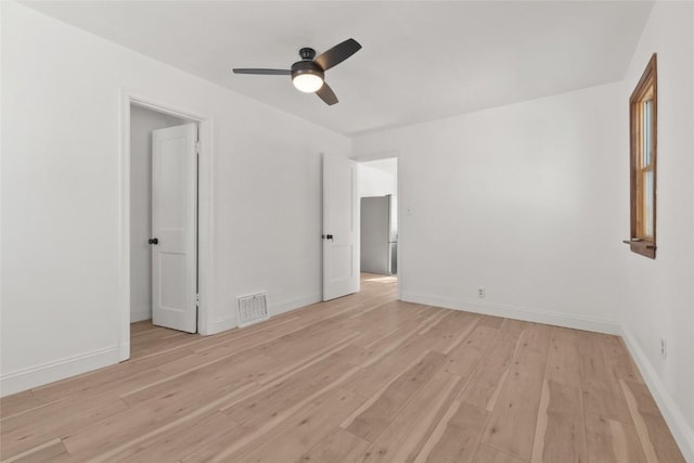 1421 Broadway St, Iowa City, IA 52240 - unfurnished room with light wood finished floors, ceiling fan, and baseboards