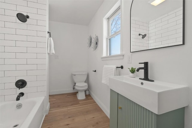 1421 Broadway St, Iowa City, IA 52240 - full bathroom featuring toilet, wood finished floors, baseboards, shower / tub combination, and vanity