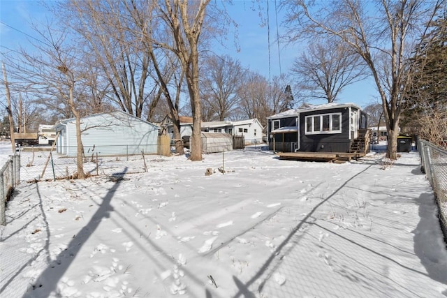 yard layered in snow featuring fence