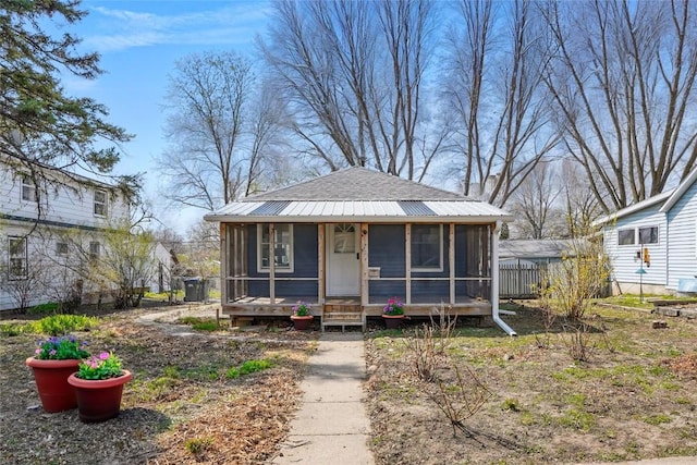 1421 Broadway St, Iowa City, IA 52240 - view of front of house with a sunroom, roof with shingles, and fence
