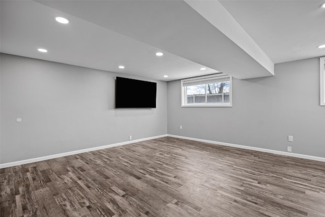 basement featuring recessed lighting, wood finished floors, and baseboards