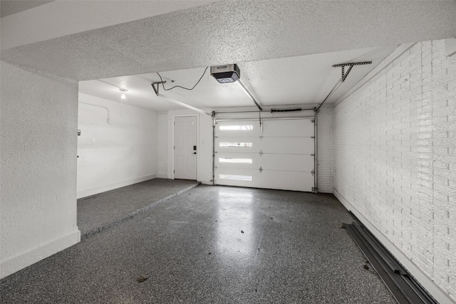 garage featuring a garage door opener and baseboards