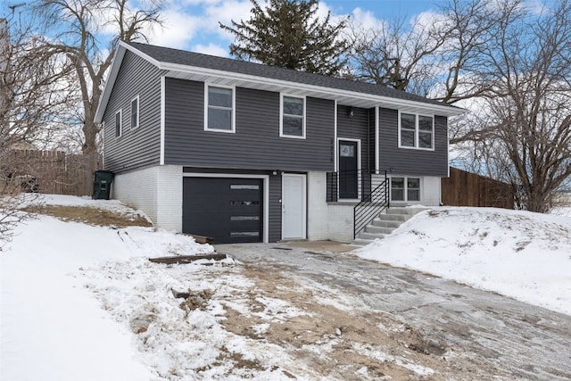 split foyer home with a garage and brick siding