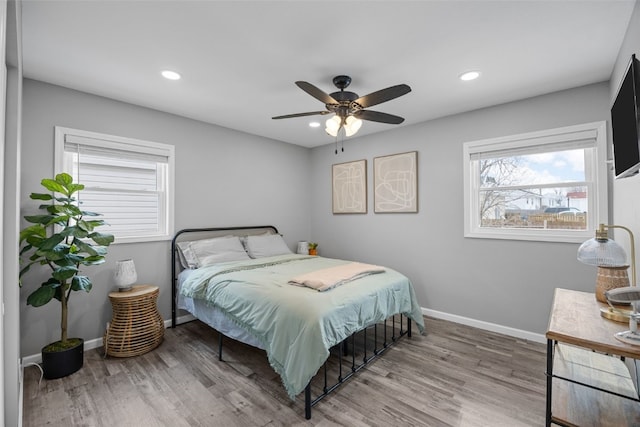 bedroom featuring recessed lighting, wood finished floors, and baseboards