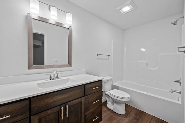 full bathroom with shower / bathing tub combination, vanity, toilet, and wood finished floors