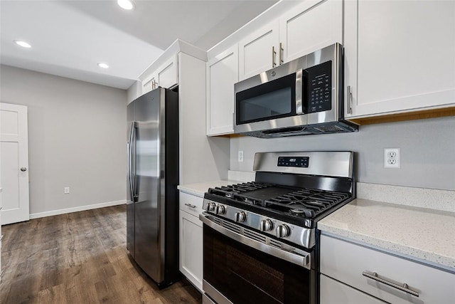 kitchen with dark wood finished floors, light stone countertops, stainless steel appliances, white cabinetry, and recessed lighting