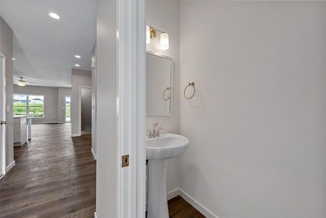 bathroom featuring baseboards, a ceiling fan, wood finished floors, a sink, and recessed lighting