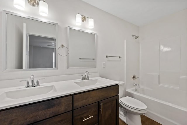 full bathroom with shower / bath combination, double vanity, toilet, and a sink