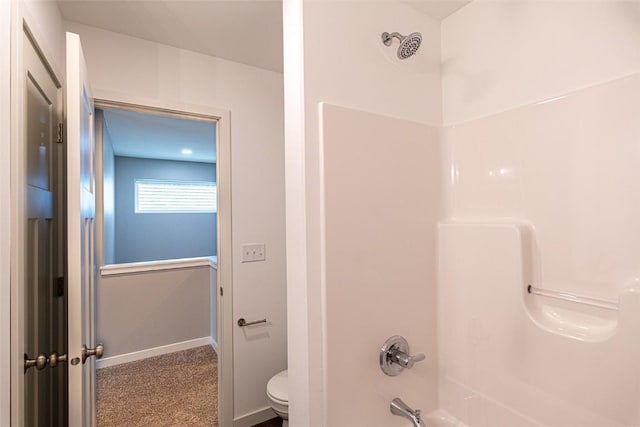 full bath featuring bathtub / shower combination, toilet, and baseboards