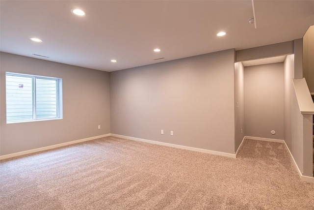 empty room featuring recessed lighting, carpet flooring, and baseboards