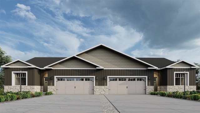 craftsman-style home featuring an attached garage, stone siding, board and batten siding, and concrete driveway