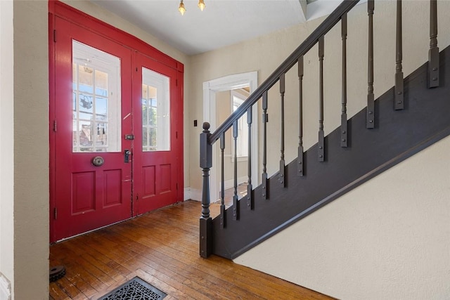 entrance foyer featuring stairs and wood finished floors