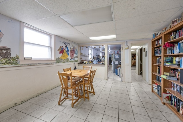 230 E Market St, Lisbon, IA 52253 - dining area with a paneled ceiling and light tile patterned flooring