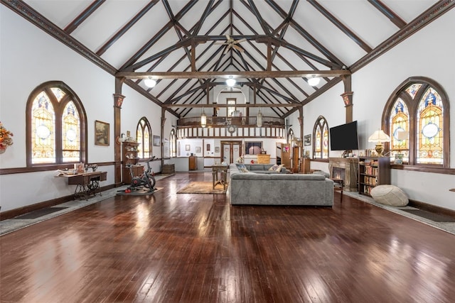 230 E Market St, Lisbon, IA 52253 - living room with baseboards, high vaulted ceiling, wood finished floors, and ornate columns