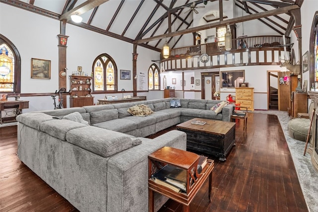 230 E Market St, Lisbon, IA 52253 - living room featuring stairway, beam ceiling, high vaulted ceiling, and dark wood-type flooring