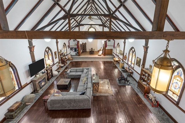 230 E Market St, Lisbon, IA 52253 - interior space with decorative columns, a glass covered fireplace, wood finished floors, high vaulted ceiling, and beamed ceiling