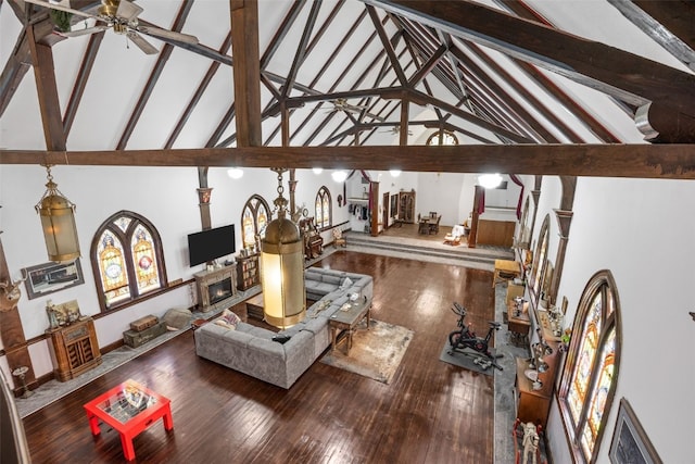 230 E Market St, Lisbon, IA 52253 - living area with a fireplace, wood finished floors, beam ceiling, and a ceiling fan