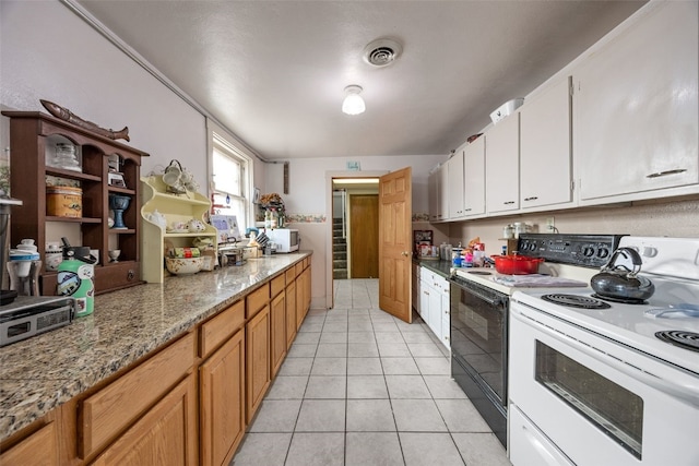 230 E Market St, Lisbon, IA 52253 - kitchen featuring visible vents, light tile patterned flooring, white cabinets, light stone countertops, and white appliances
