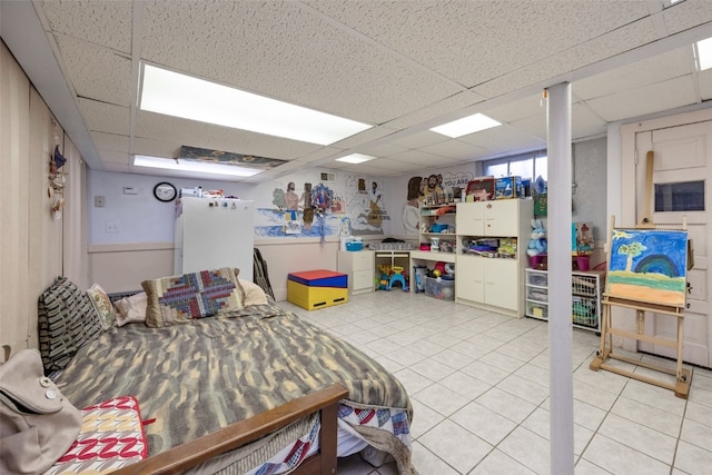 230 E Market St, Lisbon, IA 52253 - bedroom featuring light tile patterned floors, a drop ceiling, and freestanding refrigerator